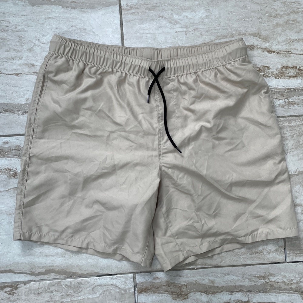 men beige swim trunks